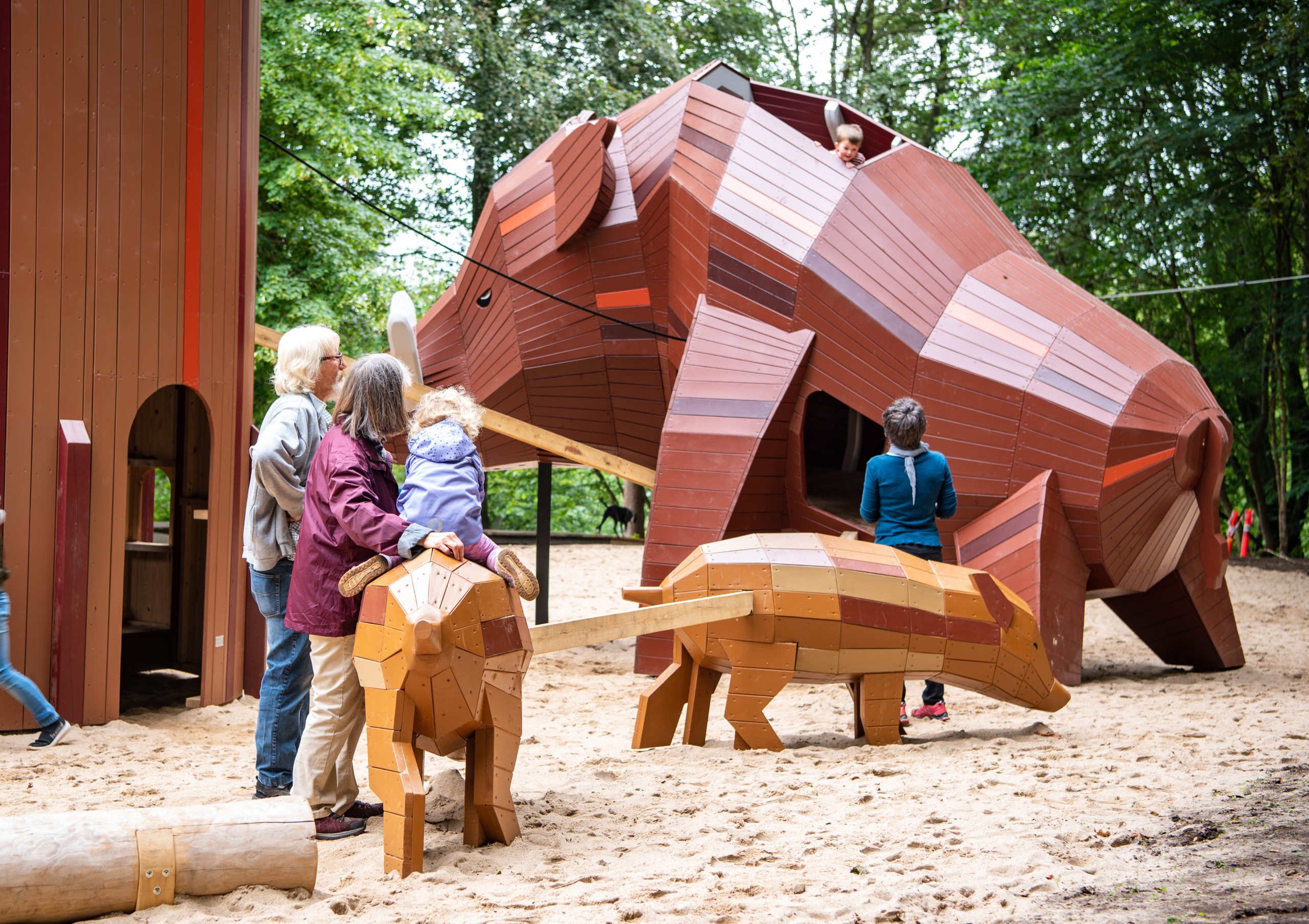 Child playing with grandparents at playground