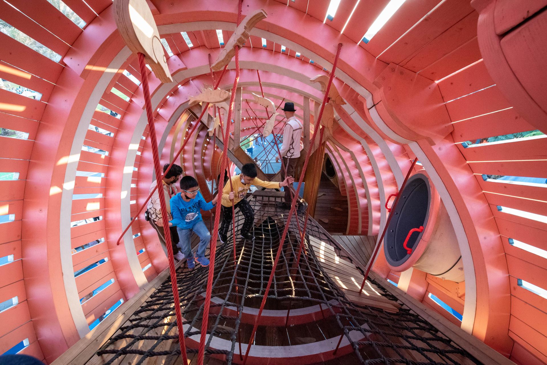 Children playing inside whale playground, MONSTRUM playgrounds