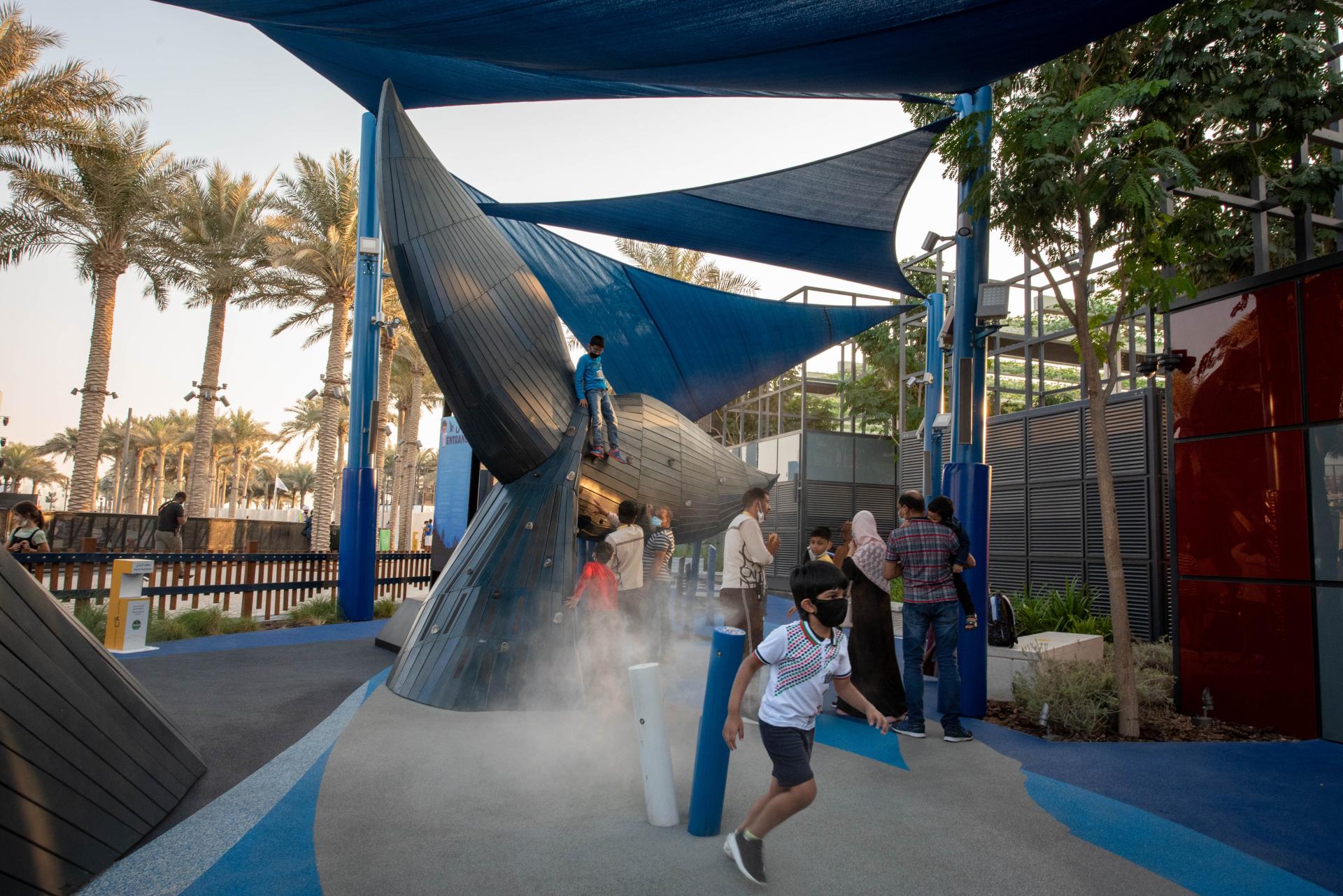 Kids playing in mist playground feature, whale playground, Expo 2020 MONSTRUM playgrounds
