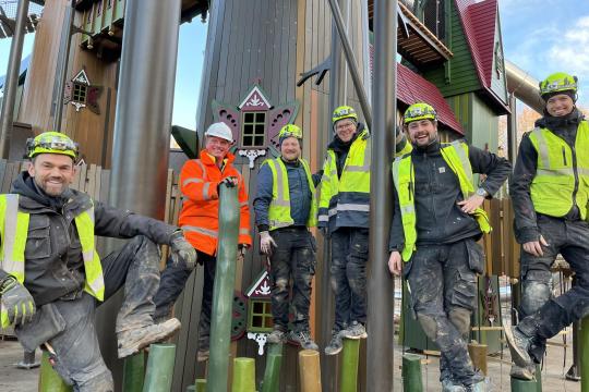 MONSTRUM craftsmen smiling for the camera at an almost completed building site of the world's largest playground
