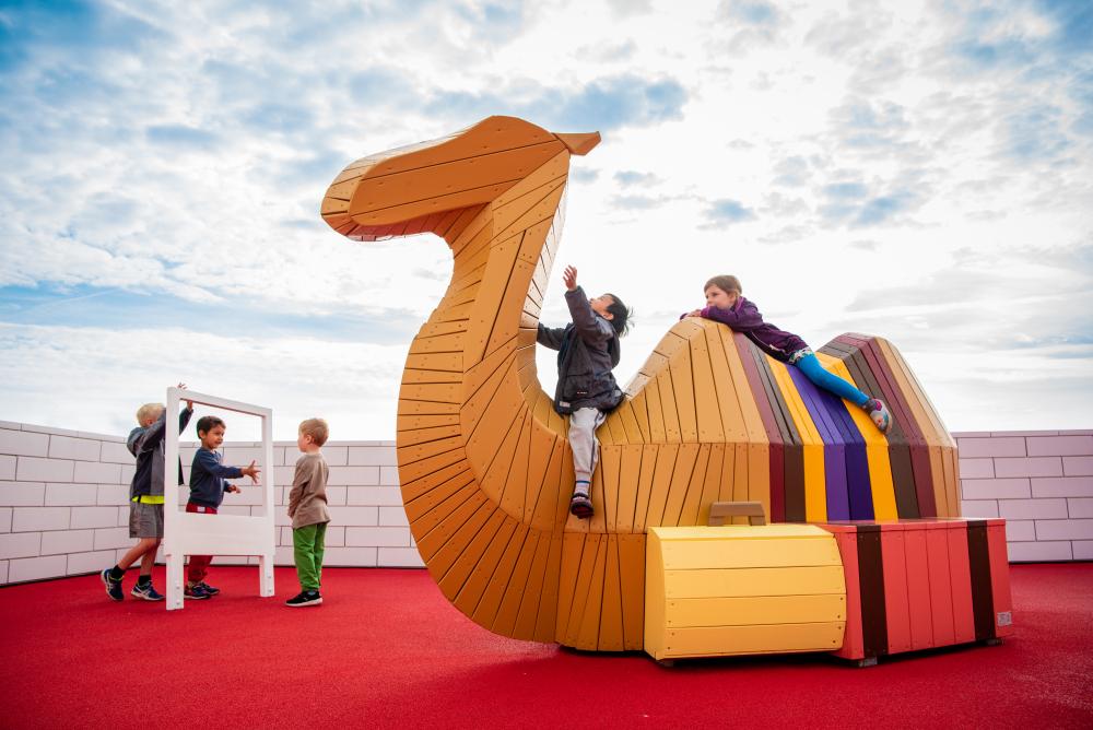 Children playing on camel play structure at LEGO House playground
