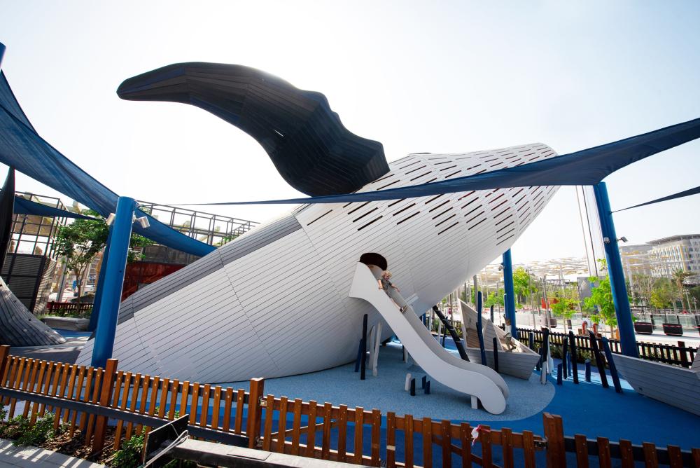 Kid playing on big slide at MONSTRUM whale playground at Expo 2020
